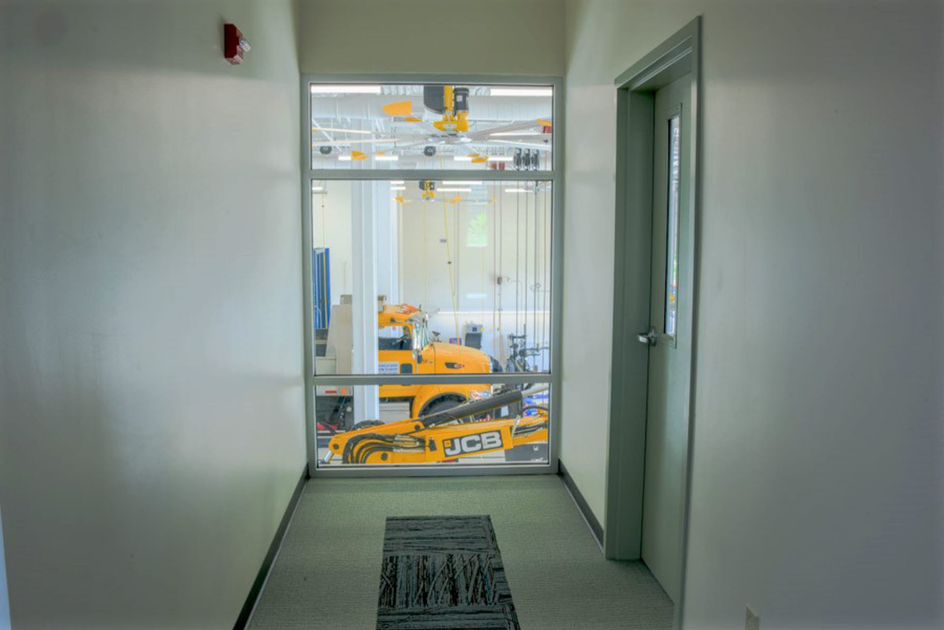 Glass Overlooking Maintenance Bays and Entrance Door to Mezzanine